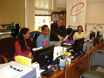 Johnny Francisco, standing, works with his team in his San Francisco office