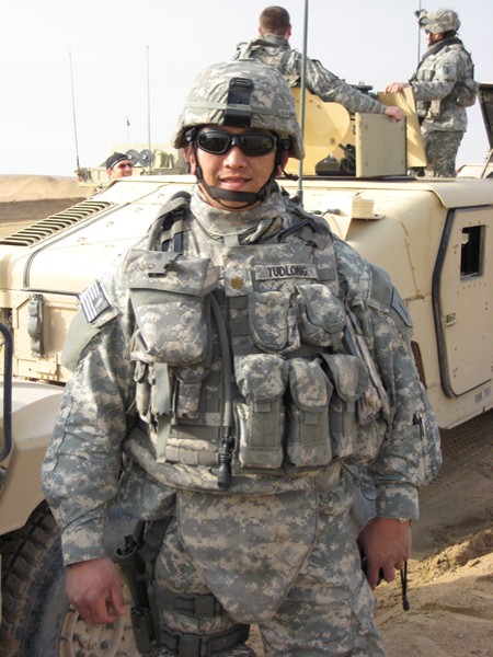 Major Ian Tudlong, his 80 lbs. gear, and his team in the background